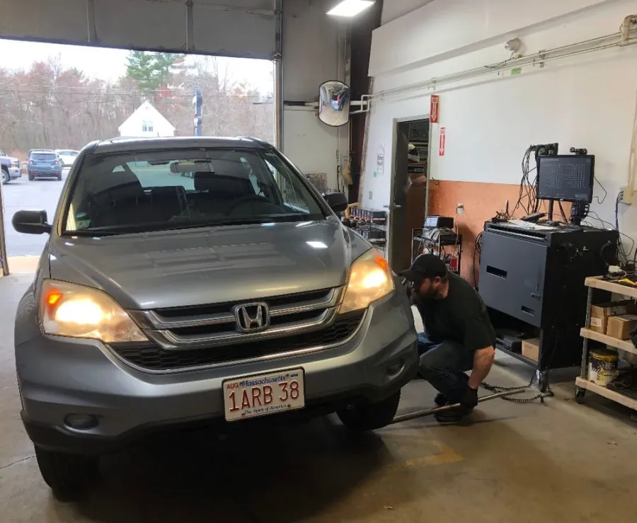 A technician checking a Honda CR-V in the Auto Tec bay